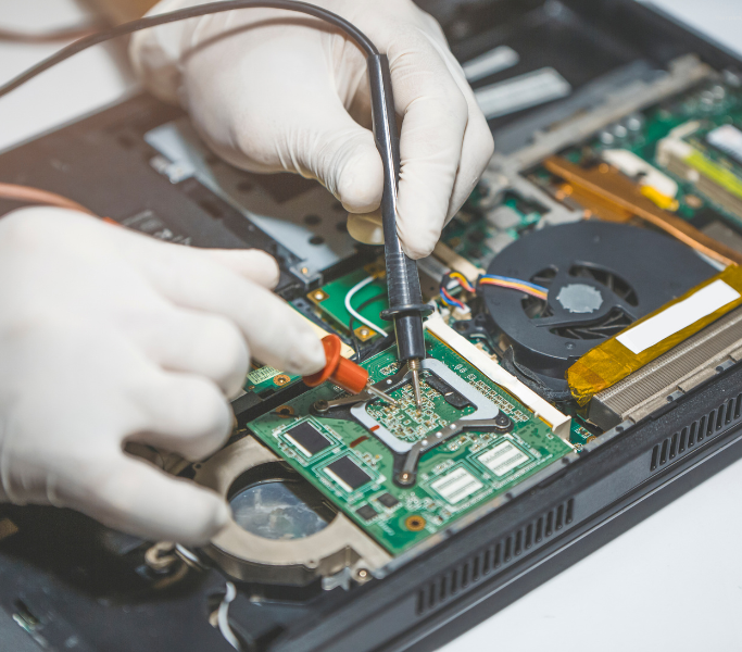 TT3 Repairs technician performing advanced laptop motherboard repair using precision electronics tools in Walmer, Port Elizabeth.